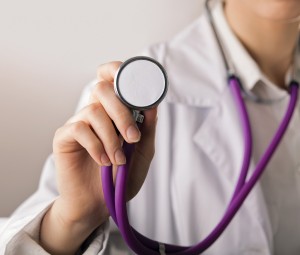 Close-up of female doctor using stethoscope , focus on stethosco