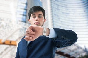 Young businessman looking at his watch