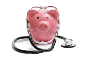 Piggy bank with stethoscope isolated on white concept for financ
