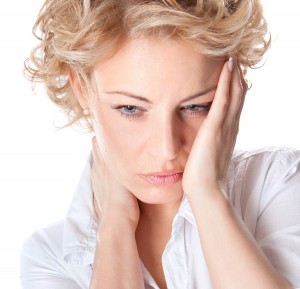 Woman with pain in her neck and head. Isolated medical shot over