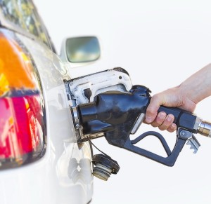 A Hand Fueling White Car.