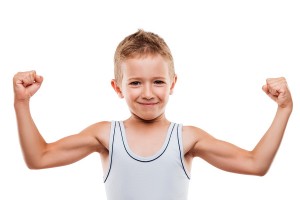 Beauty smiling sport child boy showing his hand biceps muscles s