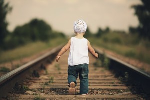 little girl plays on railroad